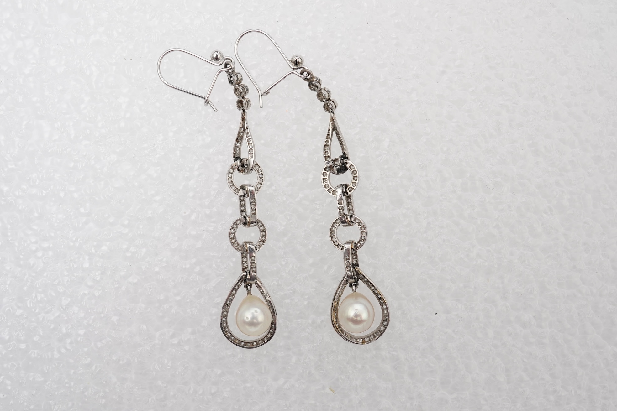 Attributed to Maurice Robin & Cie, a fine and rare pair of Art Deco natural pearl and diamond earrings, Paris, circa 1920